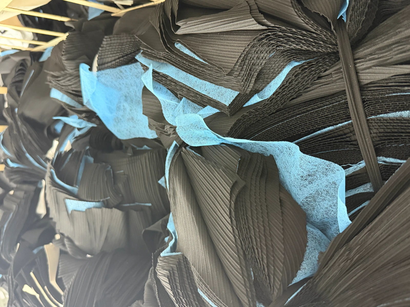 Layered garment components grouped in bundles with blue separators