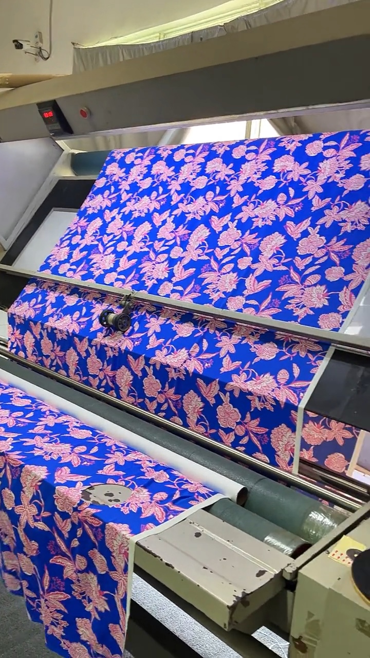 Blue patterned material arranged in separate groups at a work area.