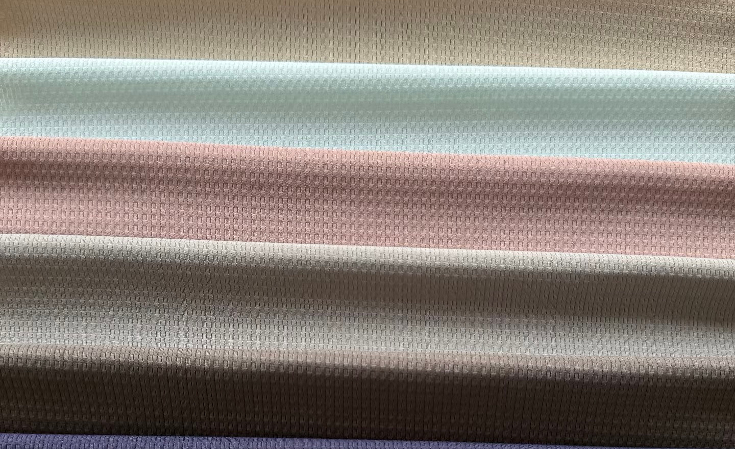 Folded textured fabric swatches in pastel colors