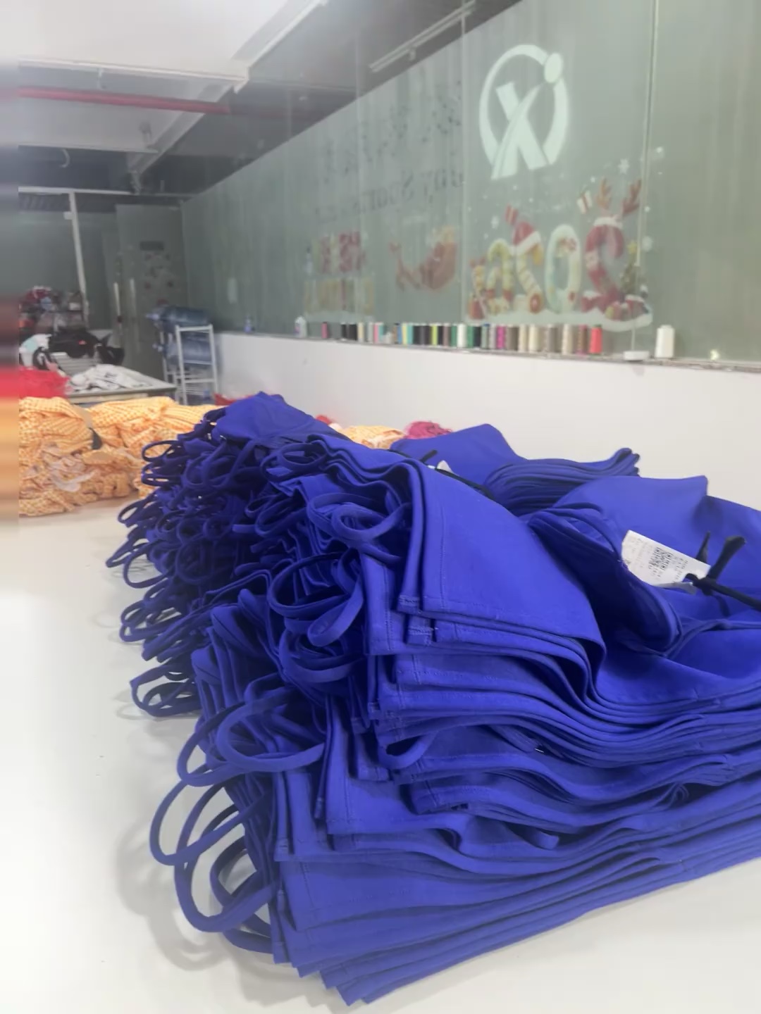 Blue garment components grouped beside a preparation table