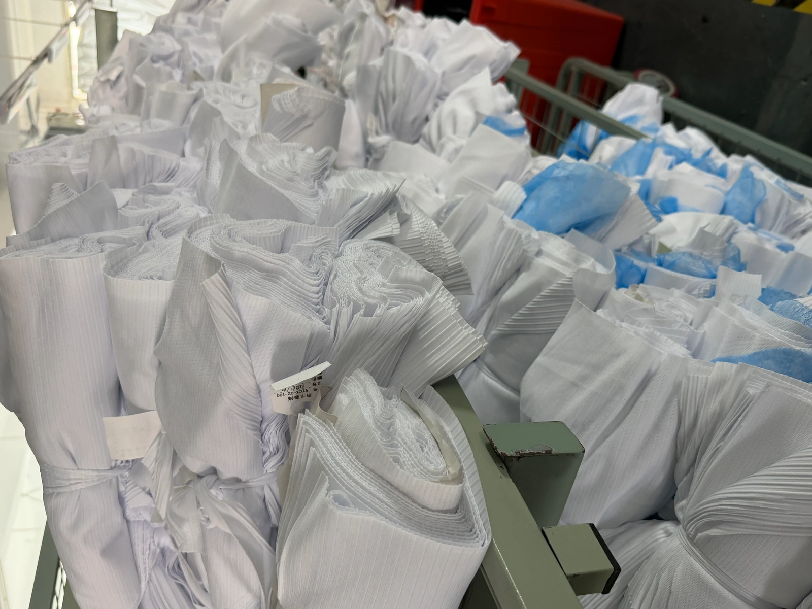 White cut garment panels grouped in bundles