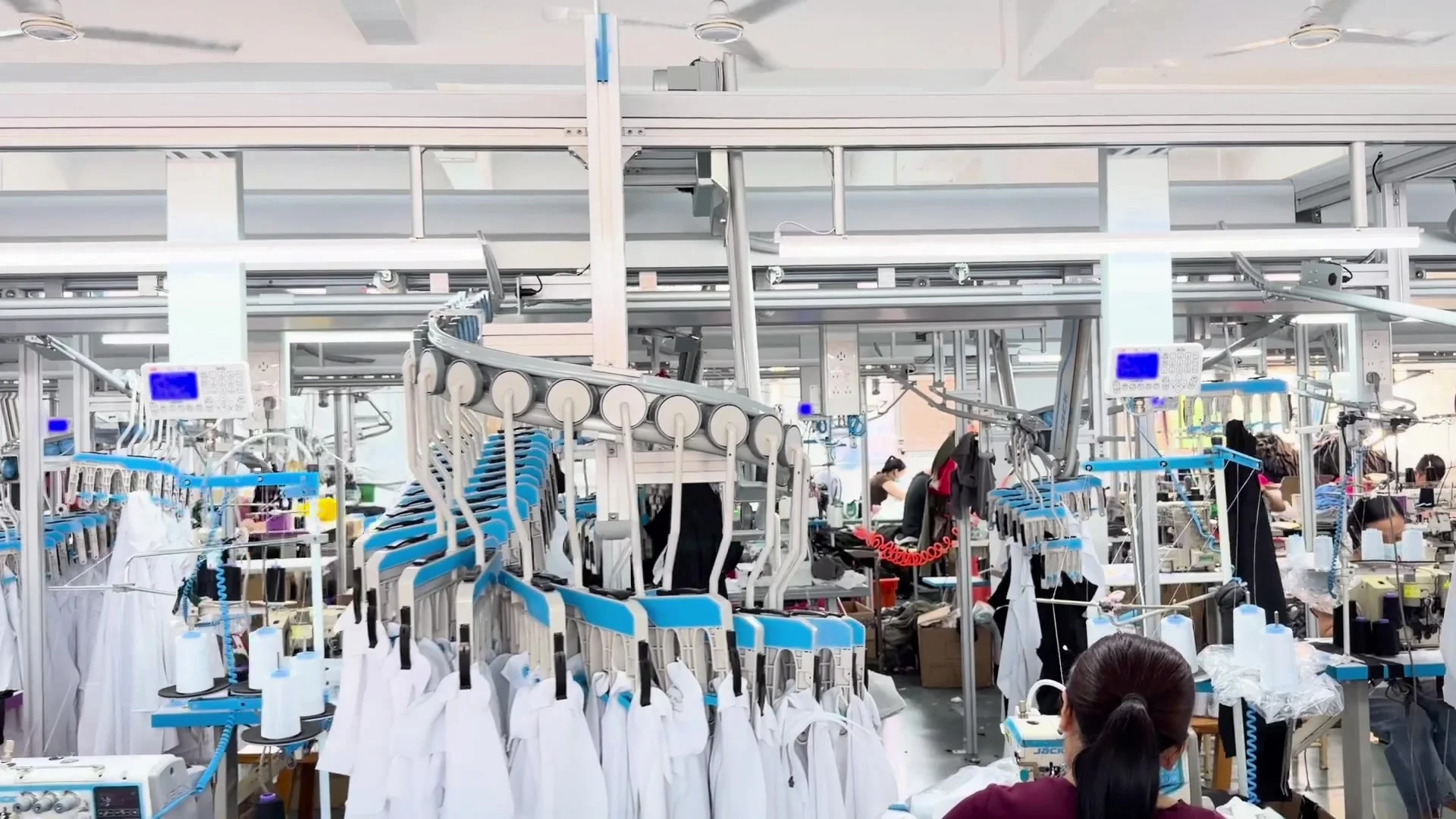 Sewing workstations and hanging garment panels on the factory production floor