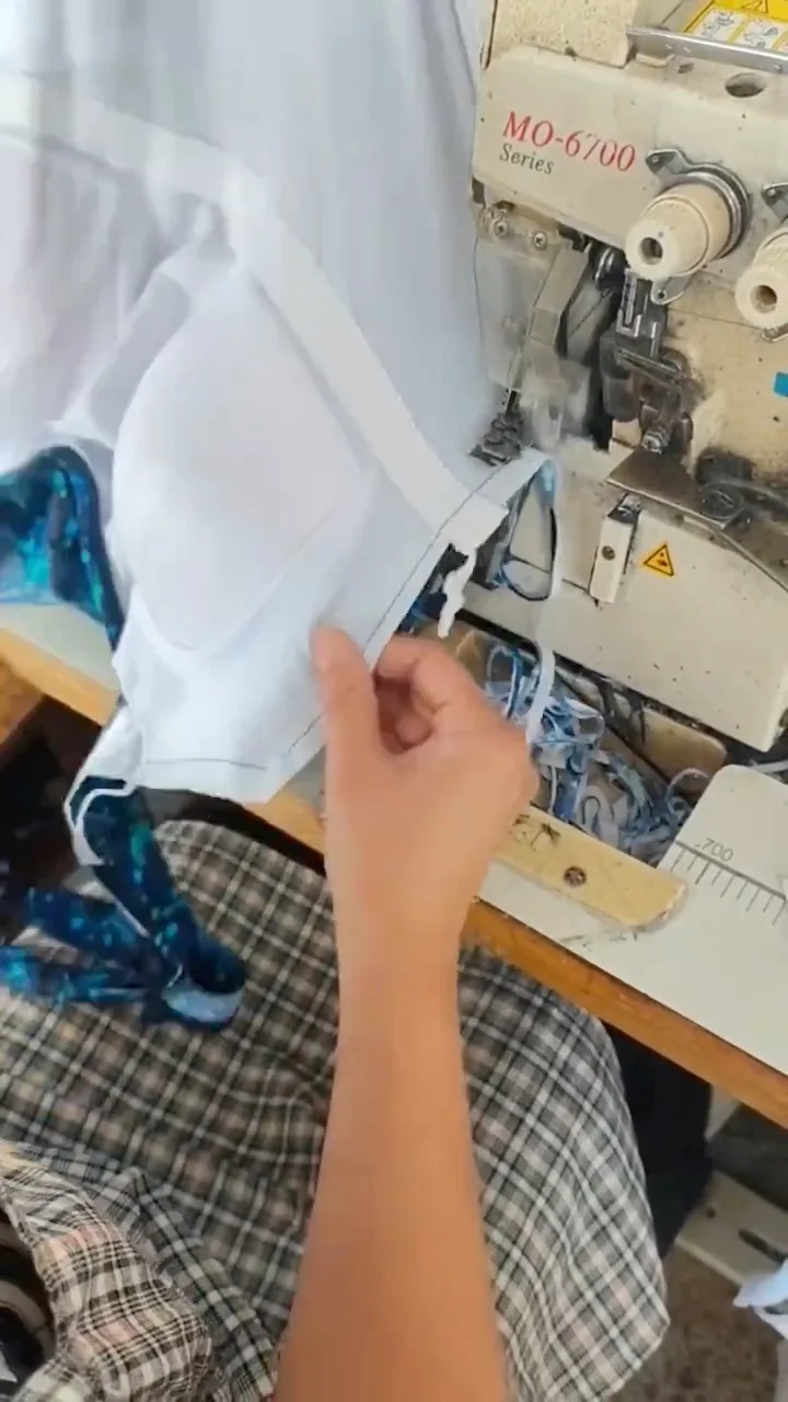 Hands aligning white lining and a patterned outer layer at the sewing point