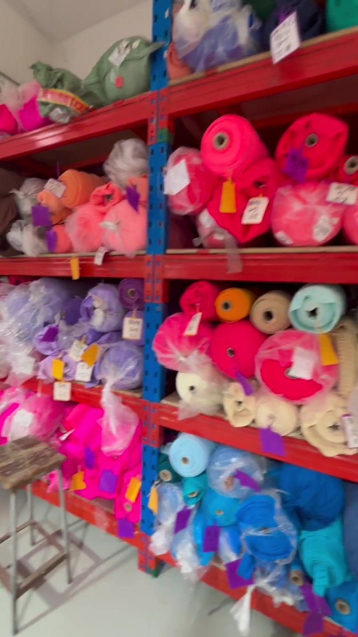 Colorful fabric rolls stored on shelving