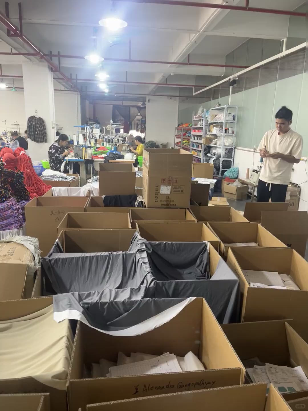 Open cartons and garments at a packing work area